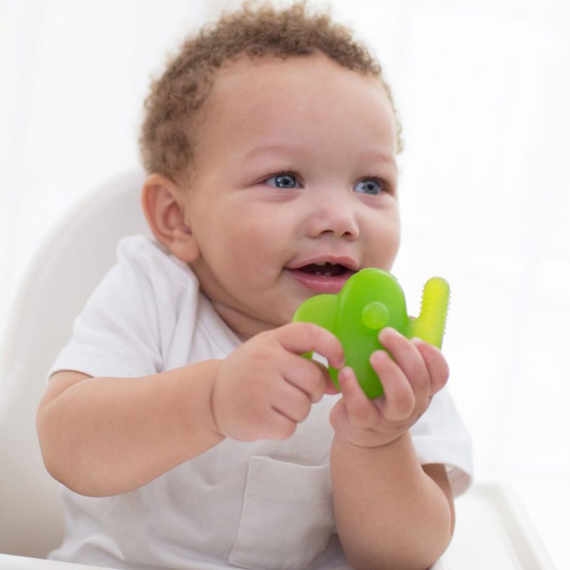 baby holding nagum teether