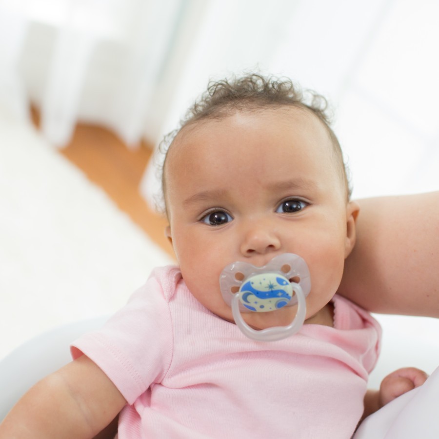 Lifestyle_Advantage_Glow_in_the_Dark_Pacifier_Stage_1_O16A0068-4 Baby in mother's arms with pacifier in mouth