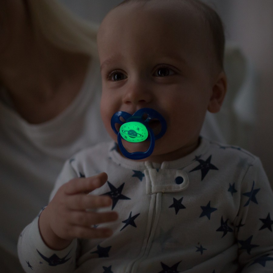 Lifestyle_Advantage_Glow_in_the_Dark_Stage_2_O16A7921 Baby in mother's arms in dark room with glow-in-the-dark pacifier in mouth